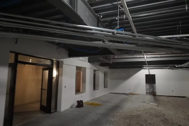 Commercial plumbing rough-in with exposed piping and drains for Highway 69 Corridor