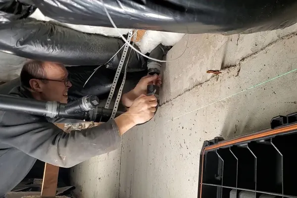 Drain cleanout and pipe connection being cleared for A vacant seasonal home in Sedona, AZ