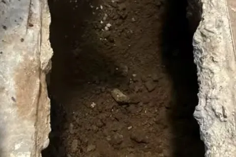 Exposed underground sewer pipe during repair for Tree roots in an old sewer line
