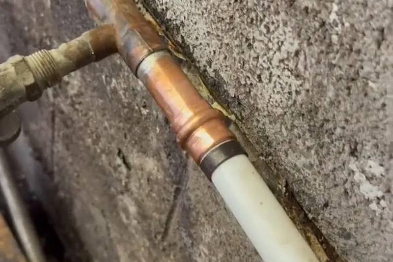 Exposed water service line with repair fittings installed for Insulating an exposed pipe