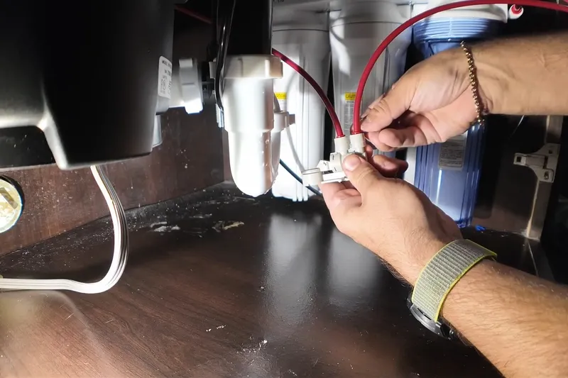 Garbage disposal unit wired below a kitchen sink for The disposal reset button in Prescott Valley, AZ