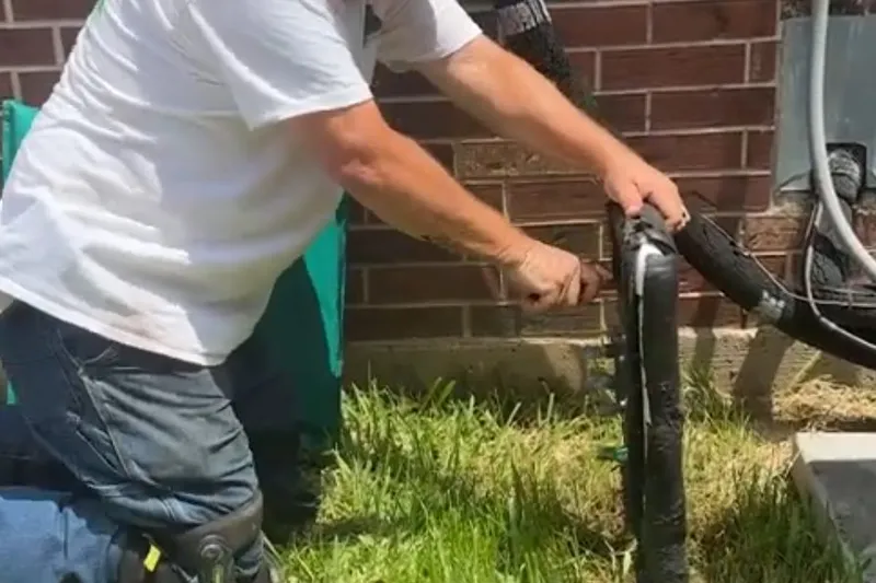 Outdoor faucet and exposed pipe connection being repaired for Fall winterizing