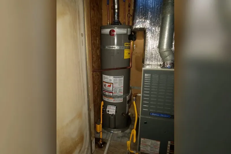 Residential water heater with visible plumbing connections for Water Heater Repair