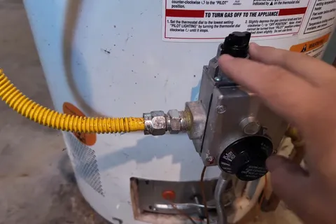 Residential water heater with visible plumbing connections for Tank vs tankless water heater comparison