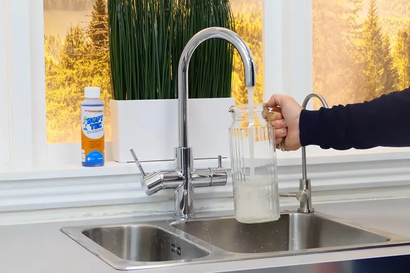 Residential water softener system with tank and plumbing connections for Water Softener Installation & Repair