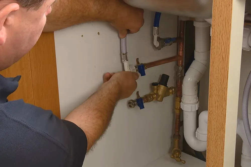 Sink faucet and under-sink drain connection being serviced for Faucet & sink repair in Prescott Valley in Prescott Valley, AZ