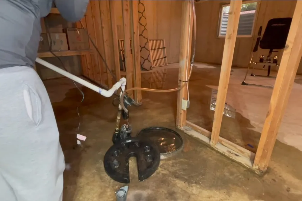 Sump pump and discharge pipe installed in a utility area for Plumber in Cottonwood, AZ in Cottonwood, AZ