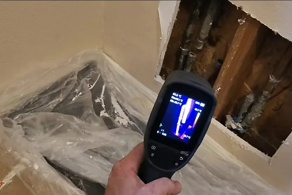 Technician checking a hidden plumbing leak in a wall or crawl space for Leak detection in Prescott Valley in Prescott Valley, AZ