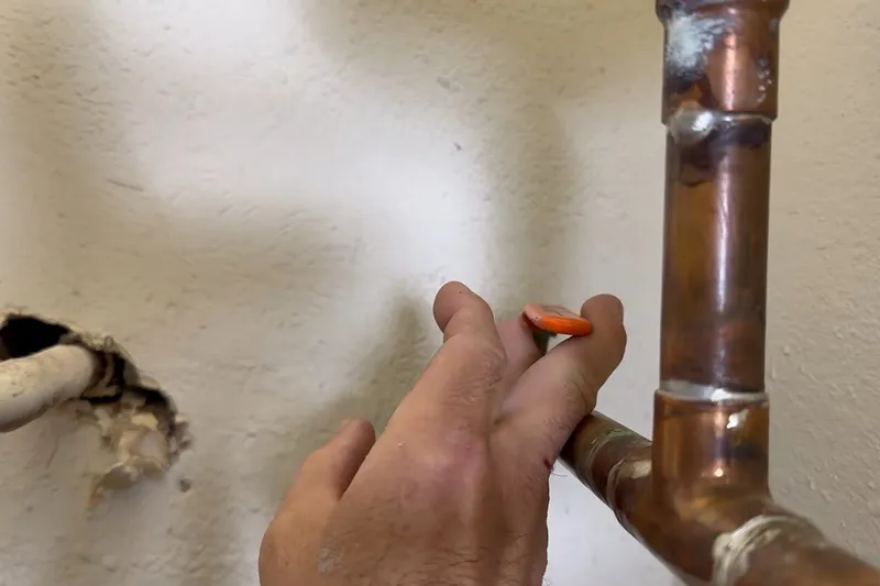 Technician checking a hidden plumbing leak in a wall or crawl space for Emergency supply line repair in Prescott Valley, AZ