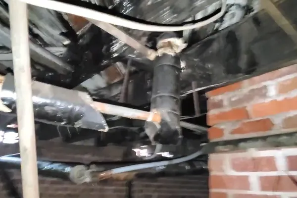Technician checking a hidden plumbing leak in a wall or crawl space for Checking the meter during a freeze in Prescott Valley, AZ