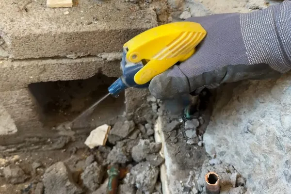 Technician checking a hidden plumbing leak in a wall or crawl space for A stain from a hidden leak in Prescott Valley, AZ