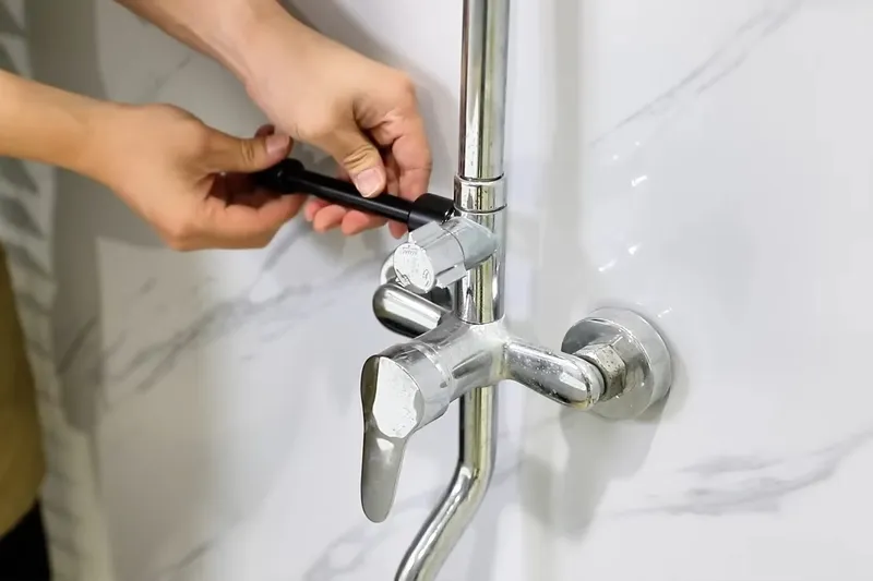 Plumbing repair tool positioned beside pipe fittings for Dewey-Humboldt